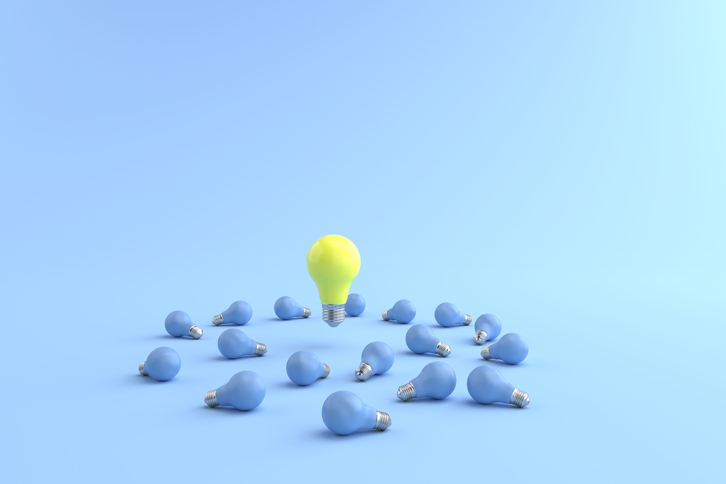 Yellow energy-saving lamp is floating on a blue light bulb placed on a pastel blue floor. and the blue background